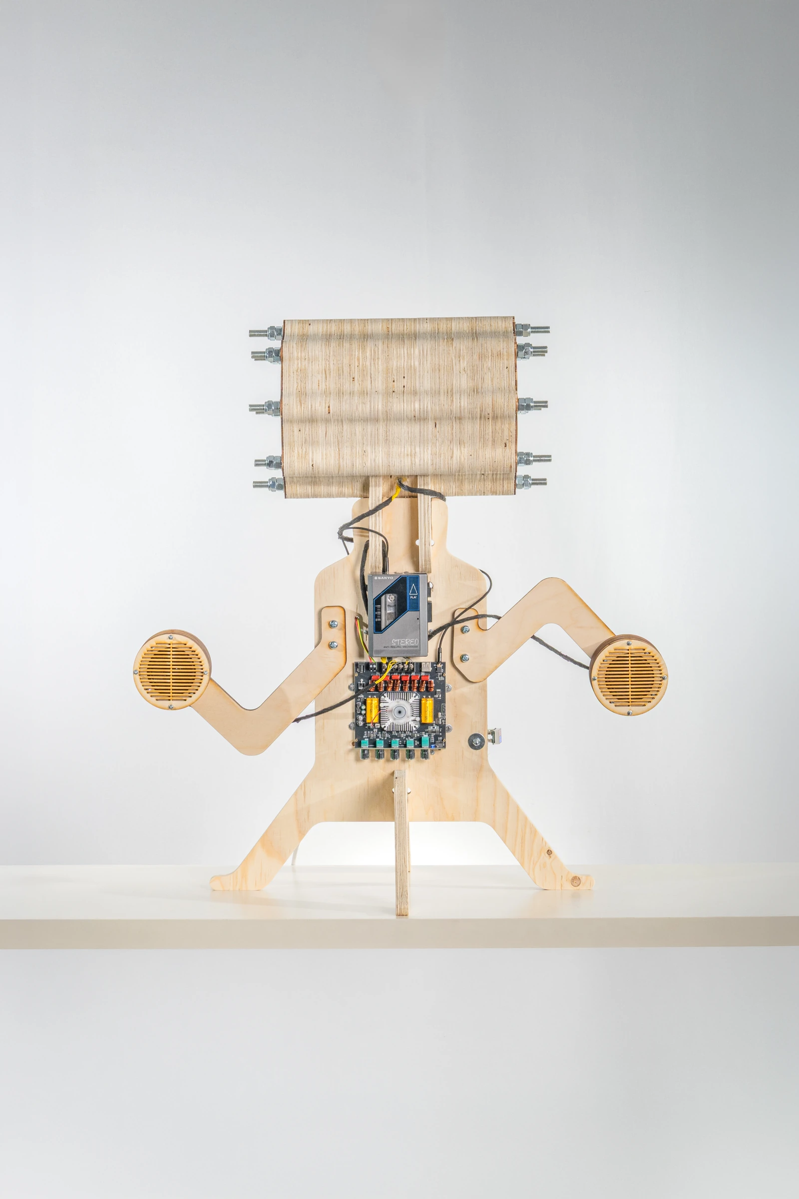 I Need Something More, a plywood creature with a cylindrical head and speakers in its arms